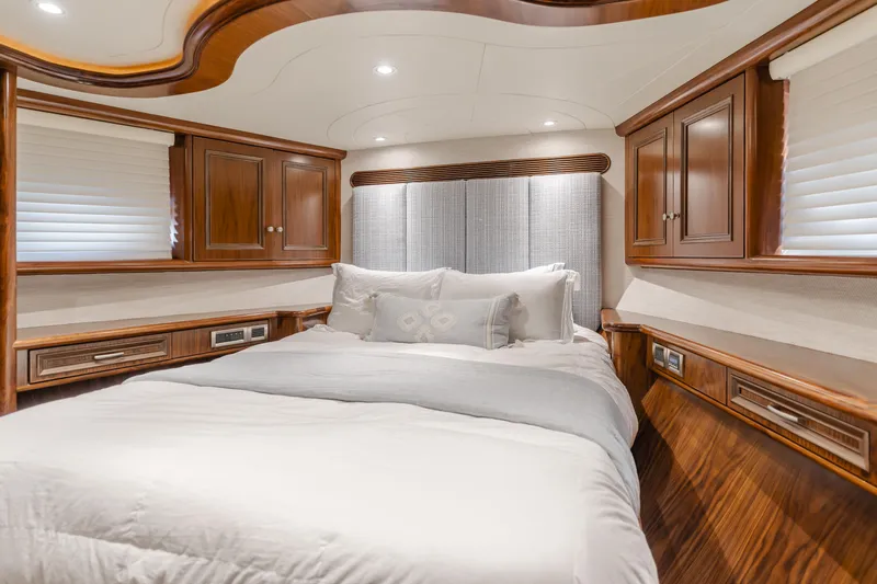 White Lotus Yacht Photos Pics Luxurious bedroom interior on 2011 President Sterling Tri-Deck yacht with wood accents and plush bedding.