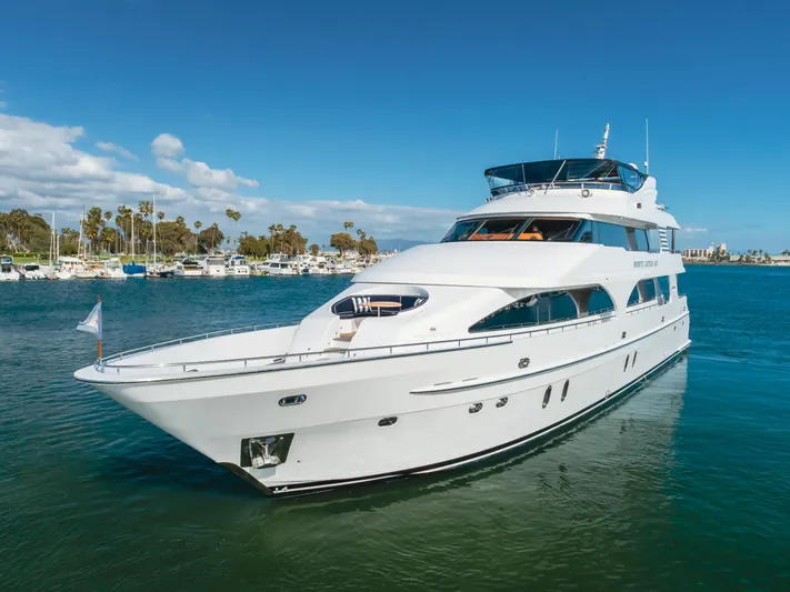 White Lotus Yacht Photos Pics Luxurious 2011 President Sterling Tri-Deck yacht cruising in a serene marina setting.