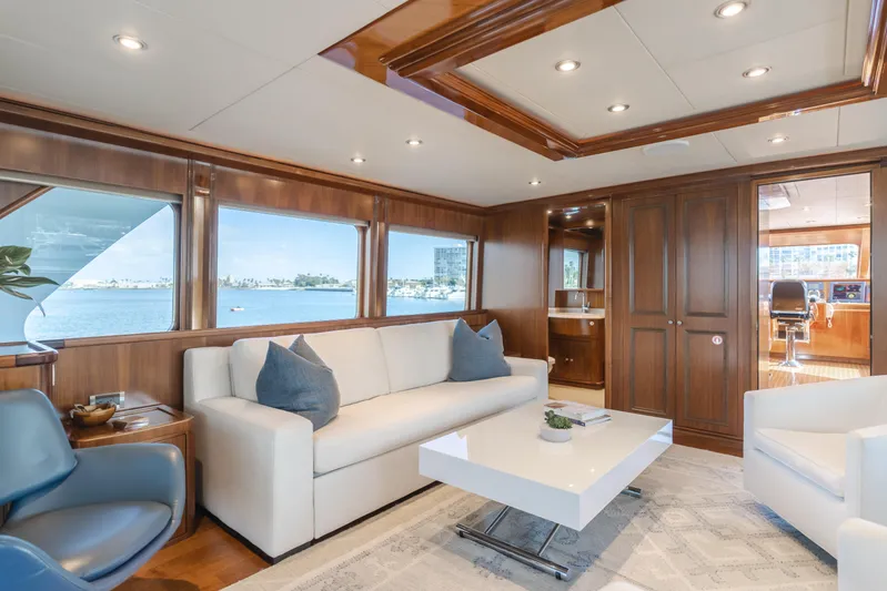 White Lotus Yacht Photos Pics Luxurious interior of 2011 President Sterling Tri-Deck yacht with elegant seating and wood paneling.