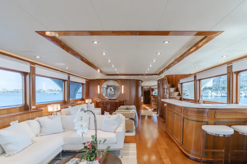 White Lotus Yacht Photos Pics Luxurious interior of 2011 President Sterling Tri-Deck yacht with elegant wood finishes and plush seating.