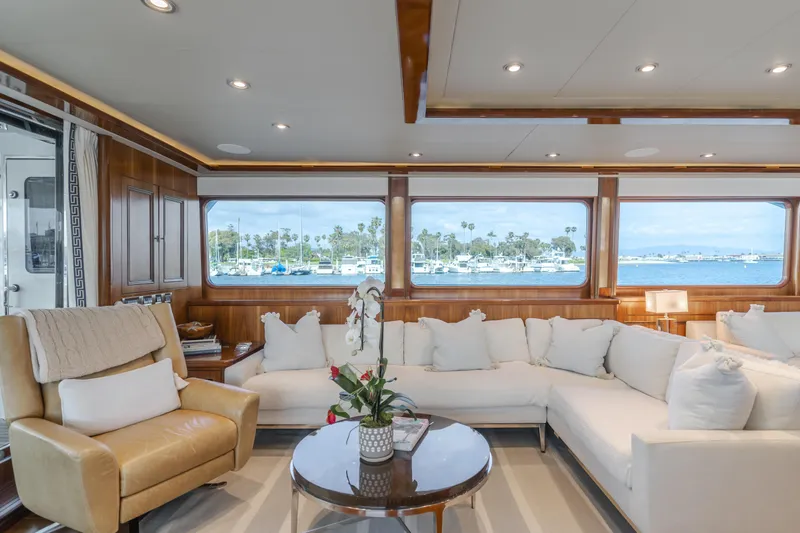 White Lotus Yacht Photos Pics Luxurious interior of 2011 President Sterling Tri-Deck yacht with elegant seating and ocean view.