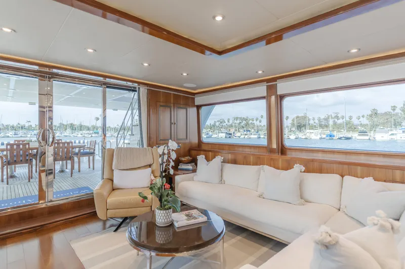 White Lotus Yacht Photos Pics Luxurious 2011 President Sterling Tri-Deck yacht interior with elegant seating and marina view.