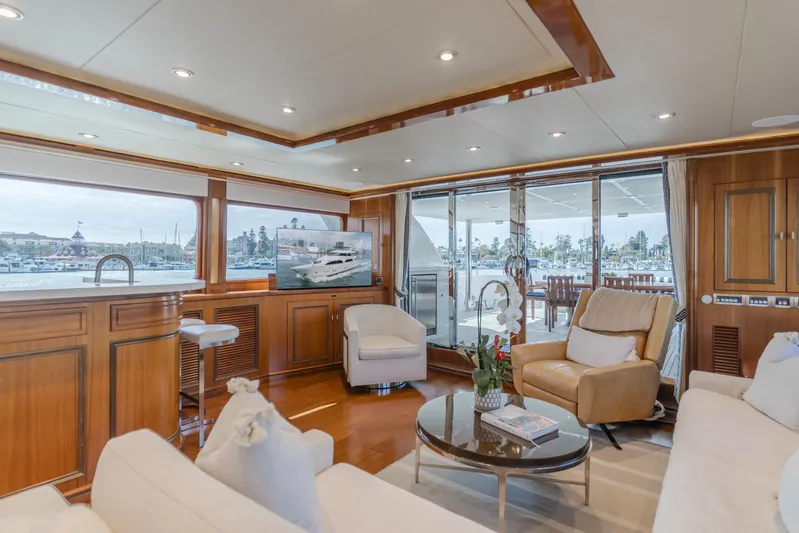 White Lotus Yacht Photos Pics Luxurious interior of 2011 President Sterling Tri-Deck yacht with elegant seating and large windows.