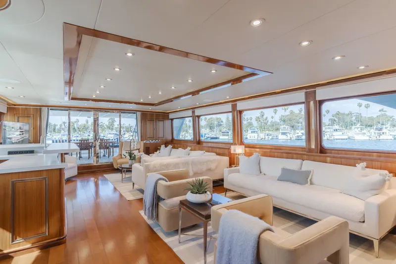 White Lotus Yacht Photos Pics Luxurious interior of 2011 President Sterling Tri-Deck yacht with elegant seating and large windows.