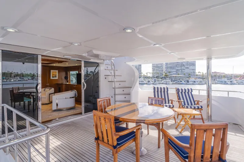 White Lotus Yacht Photos Pics Luxurious 2011 President Sterling Tri-Deck yacht with elegant outdoor seating and marina view.