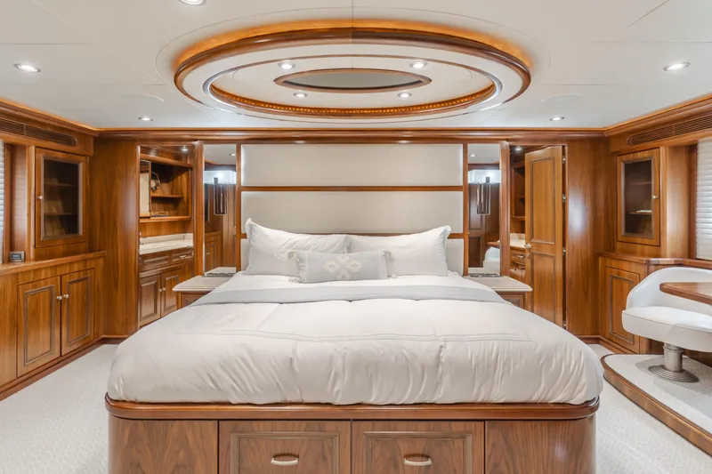 White Lotus Yacht Photos Pics Luxurious bedroom interior on 2011 President Sterling Tri-Deck yacht with elegant wood finishes.