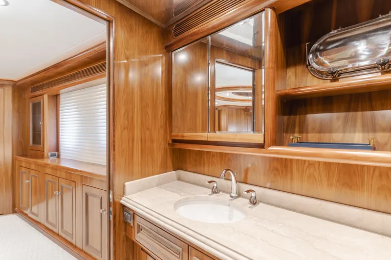 White Lotus Yacht Photos Pics Luxurious wooden interior of 2011 President Sterling Tri-Deck yacht bathroom with elegant fixtures.