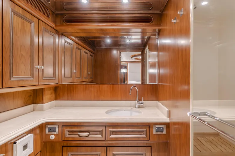 White Lotus Yacht Photos Pics Luxurious wooden interior of 2011 President Sterling Tri-Deck yacht bathroom with elegant cabinetry.