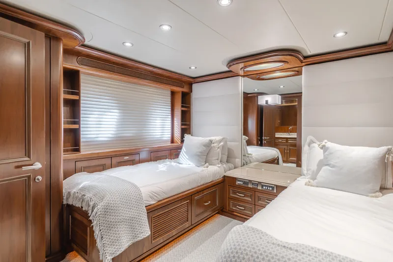 White Lotus Yacht Photos Pics Luxurious twin bedroom on 2011 President Sterling Tri-Deck yacht with elegant wood finishes.