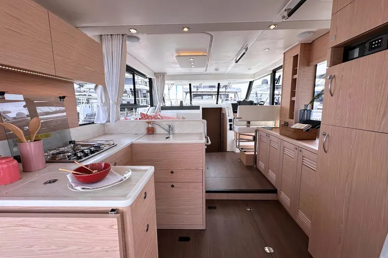  Yacht Photos Pics Luxurious interior of 2025 Beneteau Swift Trawler 41 Fly, featuring modern kitchen and seating area.