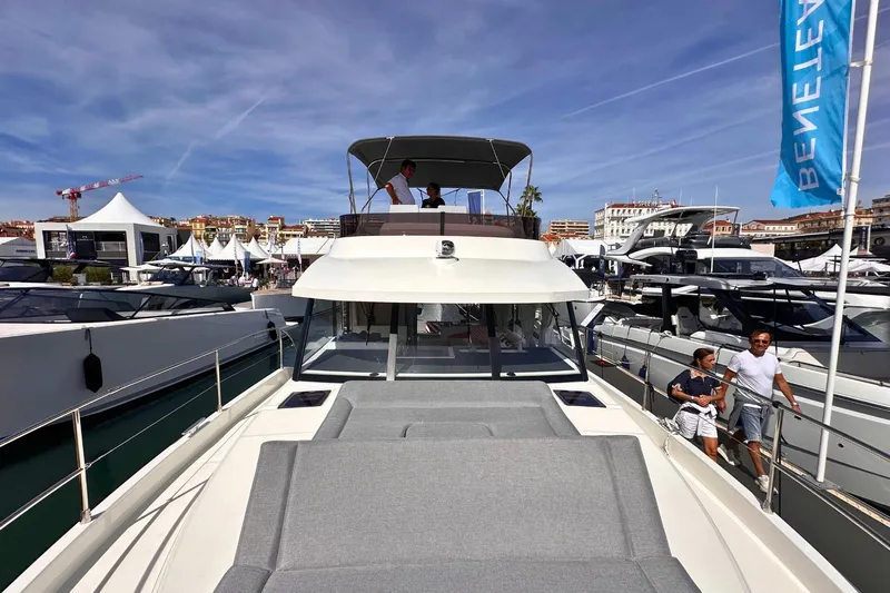  Yacht Photos Pics 2025 Beneteau Swift Trawler 41 Fly at a boat show, featuring spacious deck and flybridge.
