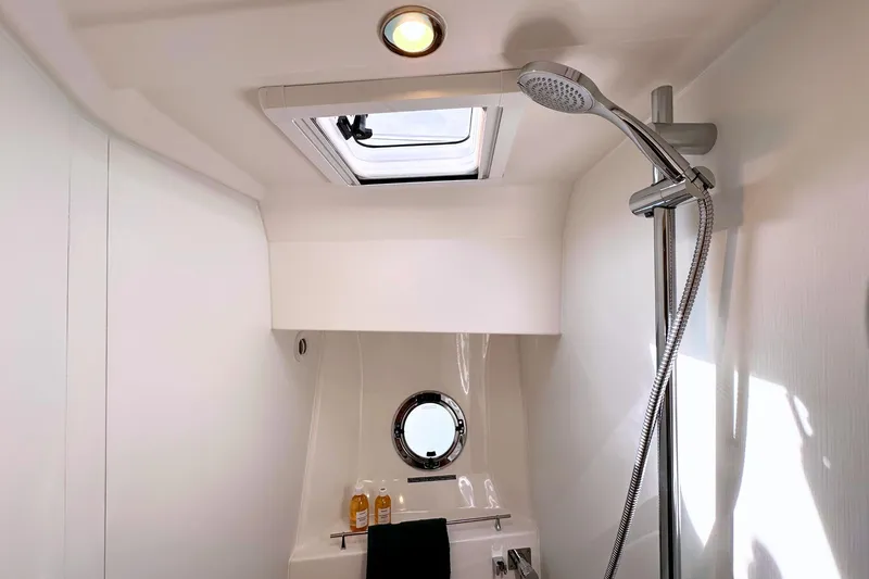  Yacht Photos Pics Bathroom interior of 2025 Beneteau Swift Trawler 41 Fly with shower and porthole.