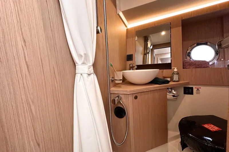  Yacht Photos Pics Luxurious bathroom in 2025 Beneteau Swift Trawler 41 Fly yacht, featuring modern fixtures.