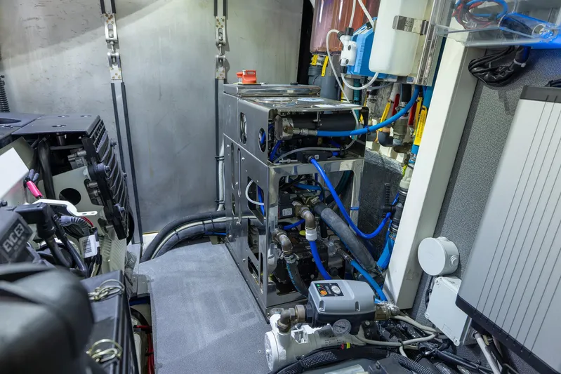 Four Sail Yacht Photos Pics Engine room of a 2020 Absolute Flybridge yacht, showcasing complex machinery and piping.