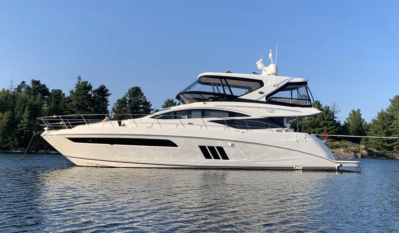 Forevermore Yacht Photos Pics 2016 Sea Ray L590 Fly yacht on calm water with trees in the background.