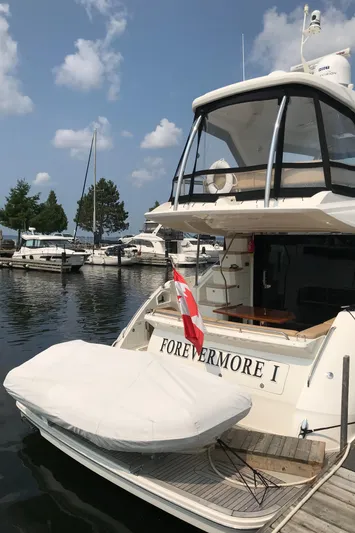 Forevermore Yacht Photos Pics 2016 Sea Ray L590 Fly yacht docked, named "FOREVERMORE I," with a covered tender.