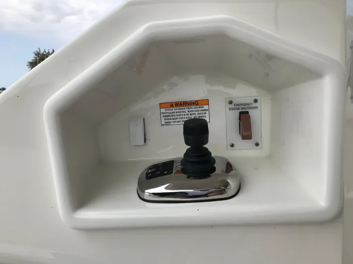 Forevermore Yacht Photos Pics Control panel of a 2016 Sea Ray L590 Fly yacht with joystick and emergency stop button.