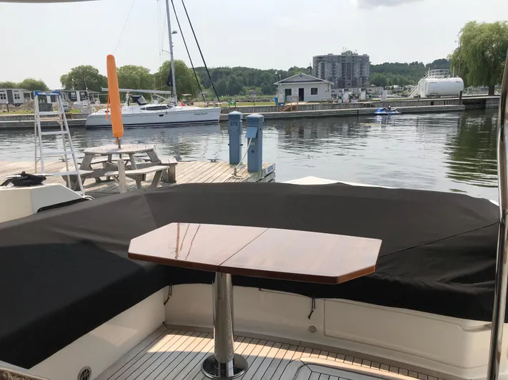 Forevermore Yacht Photos Pics 2016 Sea Ray L590 Fly yacht docked at a marina with covered seating area.