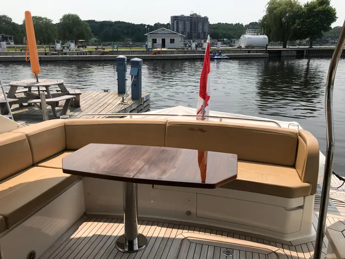 Forevermore Yacht Photos Pics 2016 Sea Ray L590 Fly yacht with outdoor seating and table by a dock.
