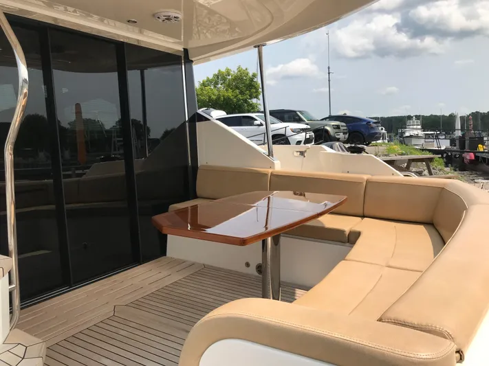 Forevermore Yacht Photos Pics Luxurious 2016 Sea Ray L590 Fly yacht with elegant outdoor seating and table.