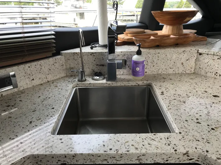 Forevermore Yacht Photos Pics Modern kitchen sink on 2016 Sea Ray L590 Fly yacht with granite countertop.
