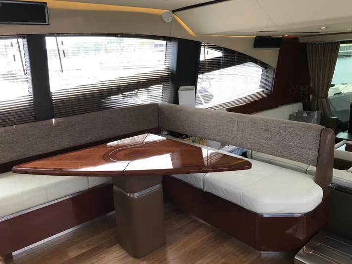 Forevermore Yacht Photos Pics Luxurious interior of 2016 Sea Ray L590 Fly yacht with elegant seating and wooden table.