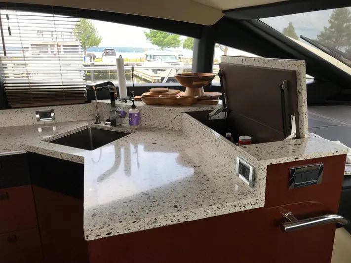 Forevermore Yacht Photos Pics Luxurious kitchen area in a 2016 Sea Ray L590 Fly yacht with modern countertops.