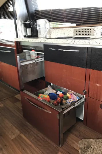 Forevermore Yacht Photos Pics 2016 Sea Ray L590 Fly yacht kitchen with open drawers, modern design, and wooden flooring.