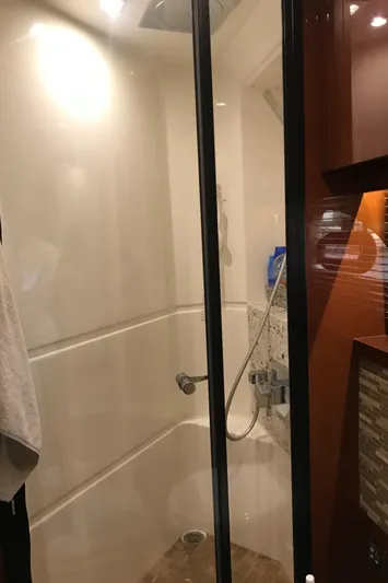 Forevermore Yacht Photos Pics Shower area in 2016 Sea Ray L590 Fly yacht, featuring modern fixtures and glass door.