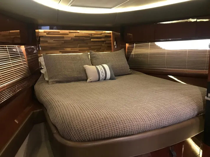 Forevermore Yacht Photos Pics Luxurious bedroom interior of 2016 Sea Ray L590 Fly yacht with elegant bedding and wood accents.