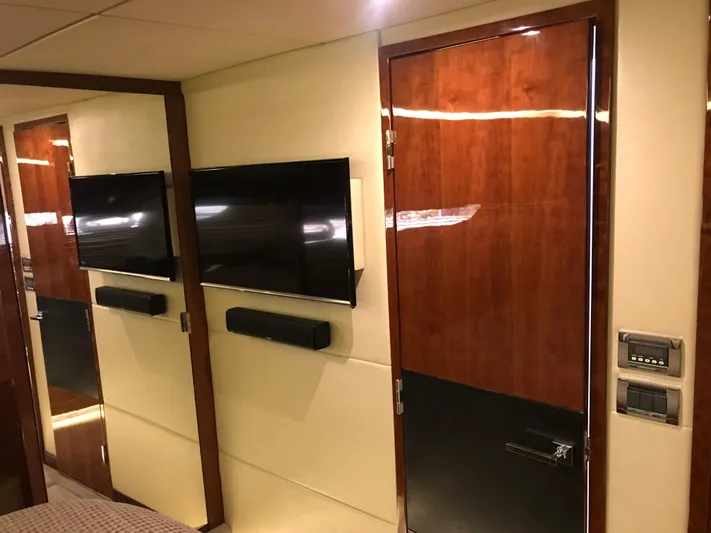 Forevermore Yacht Photos Pics Luxurious interior of 2016 Sea Ray L590 Fly yacht with modern TV and wood paneling.