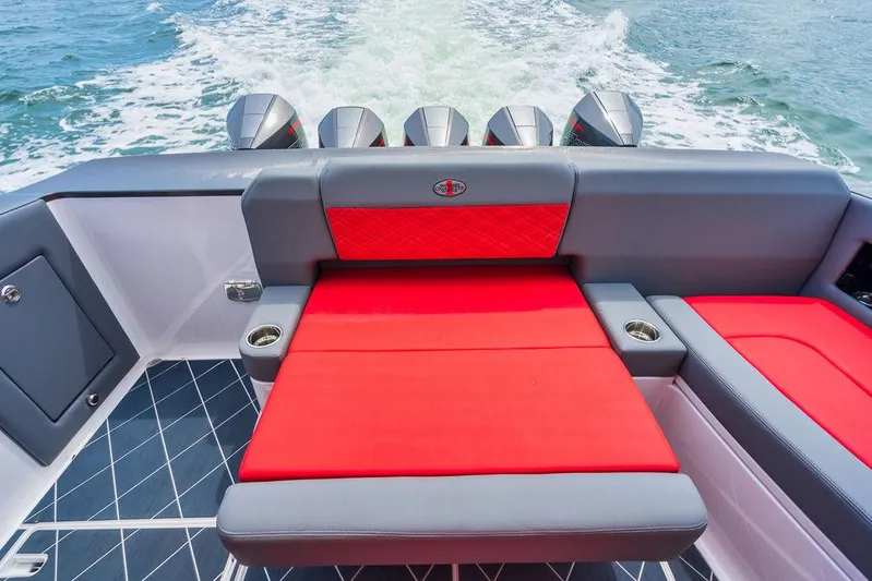 Incognito Yacht Photos Pics 2022 Cigarette 42 Nighteagle boat interior with red and gray seating, ocean view.