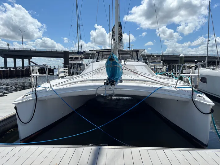 Making Memorie's Yacht Photos Pics 1999 Manta 40 catamaran docked at marina under blue sky.