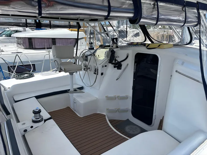 Making Memorie's Yacht Photos Pics Cockpit of 1999 Manta 40 sailboat with steering wheel and seating area.