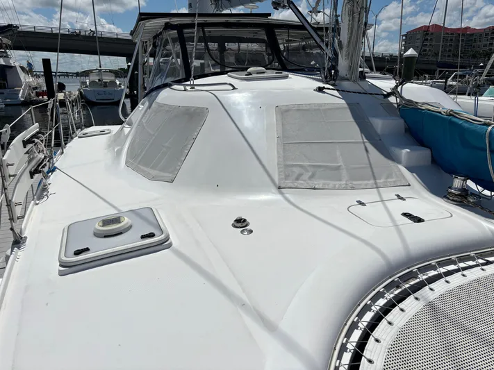 Making Memorie's Yacht Photos Pics 1999 Manta 40 yacht deck with hatches, docked at marina under blue sky.