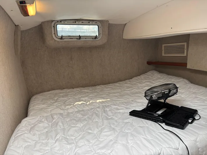 Making Memorie's Yacht Photos Pics Cozy cabin interior of a 1999 Manta 40 boat with a bed and fan.