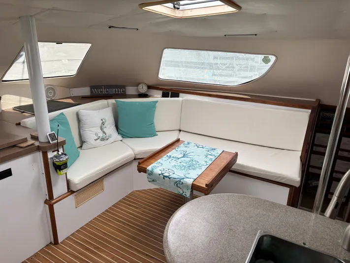 Making Memorie's Yacht Photos Pics Interior of 1999 Manta 40 yacht with cozy seating and nautical decor.