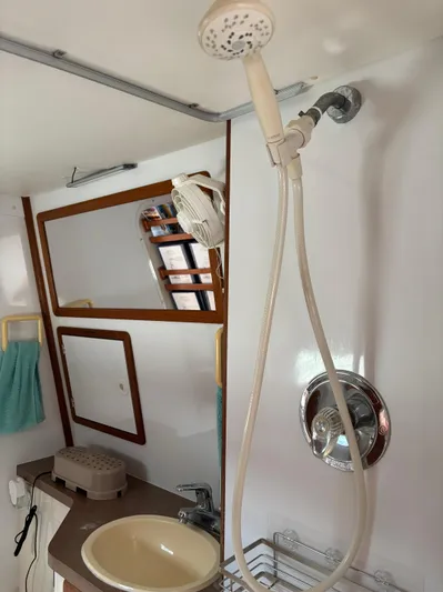 Making Memorie's Yacht Photos Pics 1999 Manta 40 yacht bathroom with shower, sink, and mirror.