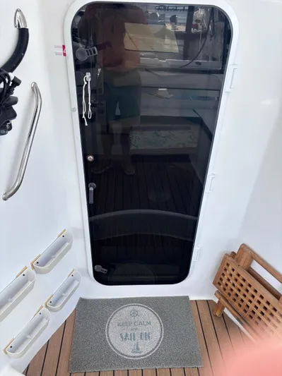 Making Memorie's Yacht Photos Pics Doorway of a 1999 Manta 40 sailboat with "Keep Calm Sail On" mat.