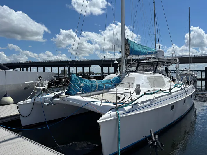 Making Memorie's Yacht Photos Pics 1999 Manta 40 catamaran docked at marina under blue sky.