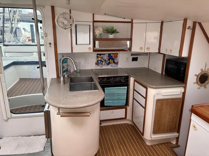 Making Memorie's Yacht Photos Pics 1999 Manta 40 yacht kitchen with modern appliances and wooden accents.