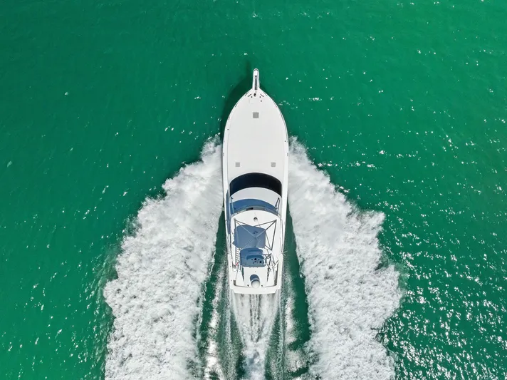 Ivelymar Yacht Photos Pics Aerial view of 2005 Viking 56 Convertible yacht cruising in turquoise waters.