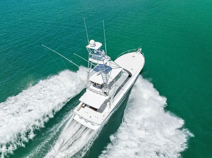 Ivelymar Yacht Photos Pics 2005 Viking 56 Convertible yacht cruising on turquoise waters, aerial view.