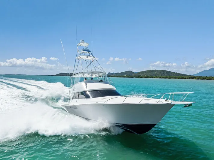 Ivelymar Yacht Photos Pics 2005 Viking 56 Convertible yacht cruising on turquoise waters under clear blue skies.