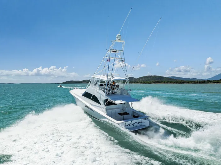 Ivelymar Yacht Photos Pics 2005 Viking 56 Convertible yacht cruising on turquoise waters under clear blue skies.