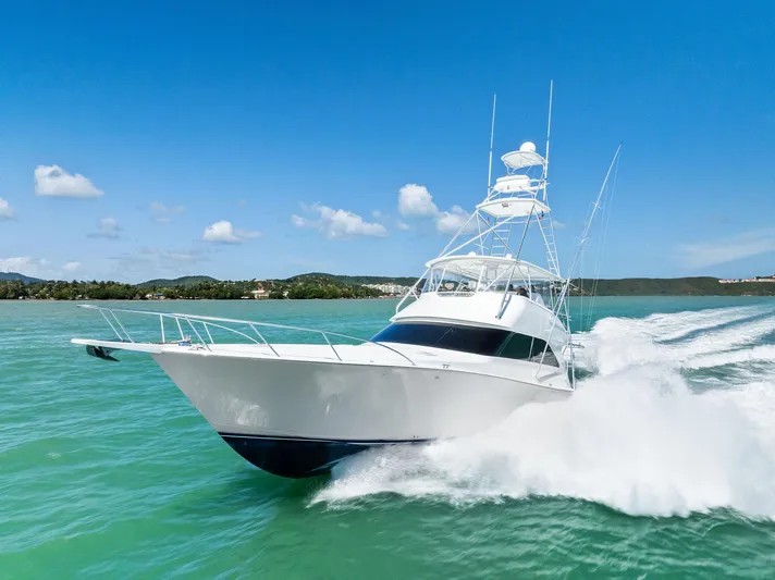 Ivelymar Yacht Photos Pics 2005 Viking 56 Convertible yacht cruising on turquoise waters under a clear blue sky.