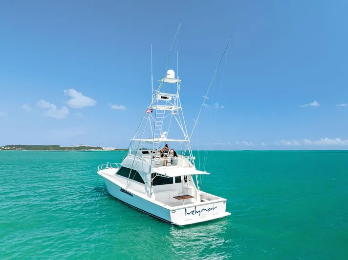 Ivelymar Yacht Photos Pics 2005 Viking 56 Convertible yacht on turquoise waters under clear blue sky.