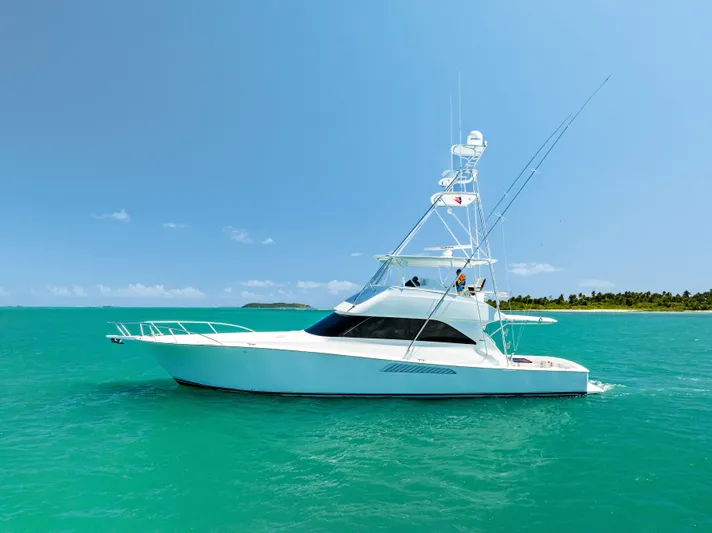 Ivelymar Yacht Photos Pics 2005 Viking 56 Convertible yacht on turquoise water near tropical island.