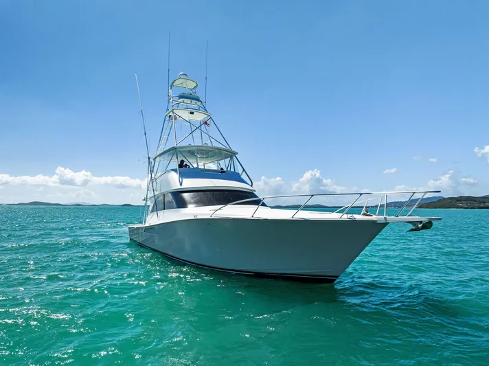 Ivelymar Yacht Photos Pics 2005 Viking 56 Convertible yacht on turquoise water under clear blue sky.