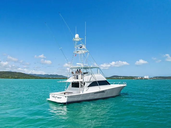 Ivelymar Yacht Photos Pics 2005 Viking 56 Convertible yacht on turquoise water under clear blue sky.